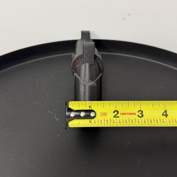 Brick style revolver replica front view with tape measure showing barrel opening width.
