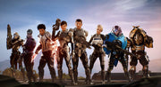 Promotional image of the Mass Effect: Andromeda squad standing side by side in futuristic armor, including human and alien characters holding advanced sci-fi weapons against a bright sky backdrop.