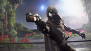 A hooded futuristic character aiming a sleek sci-fi handgun, standing in a lush alien landscape with glowing plants and a cosmic sky in the background.