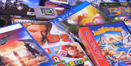 A mix of retro and modern video game cases and cartridges, showcasing multiple gaming eras.