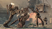 Two armored soldiers attack a hulking enemy in a ruined city, as one delivers a flying kick and the other fires a shotgun, with explosions and debris erupting in the background.