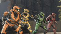 Four Halo Spartans in orange, yellow, green, and red armor facing off in Halo multiplayer