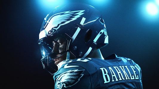 Philadelphia Eagles Running Back Saquon Barkley wearing a helmet under stadium lights.