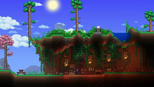A vibrant Terraria scene showing a player-built underground base hidden beneath a grassy hilltop with tall trees, vines, lanterns, and crafting stations, under a bright blue sky with the sun shining.