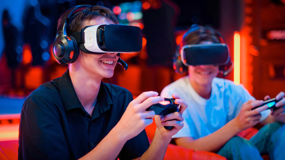 Two people wearing VR headsets and gaming headsets sit side by side, smiling while holding controllers. They appear to be enjoying a multiplayer VR gaming session in a colorful, neon lit gaming environment.