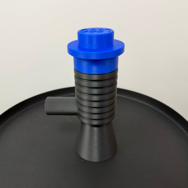 Brick style megaphone blaster replica with blue top piece, 3D printed block style prop displayed on table.