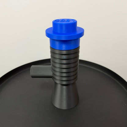 Brick style megaphone blaster replica with blue top piece, 3D printed block style prop displayed on table.