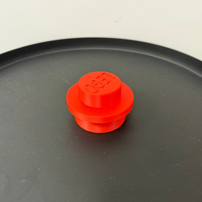 Close up of red brick style blaster top piece with block inspired design.