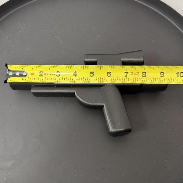 Brick style blaster replica with tape measure showing the overall length of the 3D printed prop.