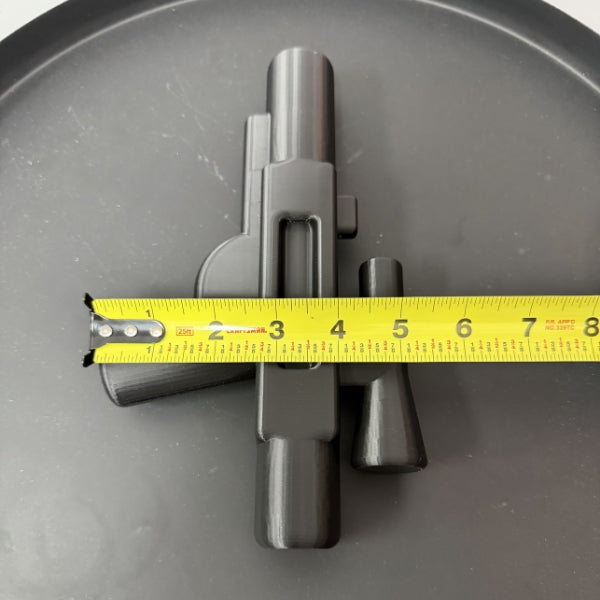 Top view of brick style blaster replica with tape measure showing the width of the 3D printed prop.