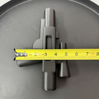 Top view of brick style blaster replica with tape measure showing the width of the 3D printed prop.