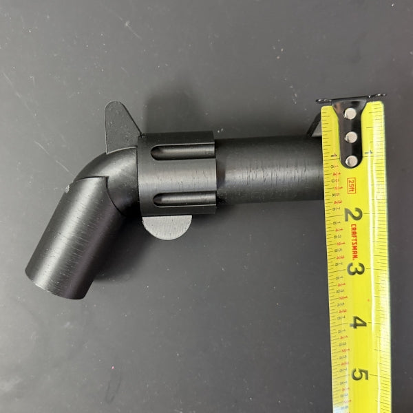 Brick style revolver replica with tape measure measuring height of the barrel.