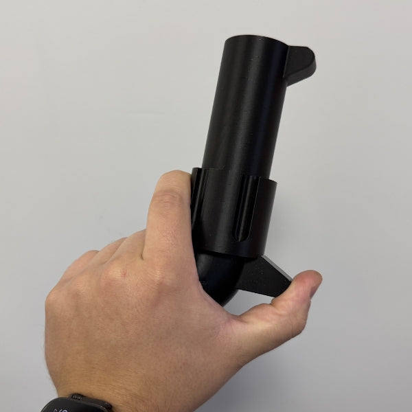 Brick style revolver replica held in hand demonstrating the size and grip of the prop.