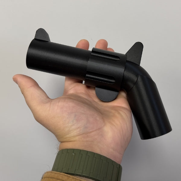 Brick style revolver replica resting in hand showing compact size of the 3D printed prop.