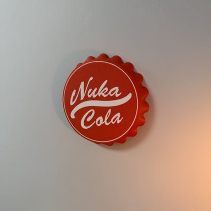Nuka Cola bottle cap wall hook replica mounted on wall as Fallout inspired gaming room decor.