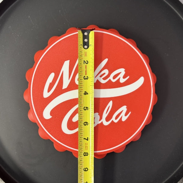 Nuka Cola bottle cap wall hook replica with tape measure showing overall diameter of the 3D printed prop.