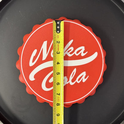 Nuka Cola bottle cap wall hook replica with tape measure showing overall diameter of the 3D printed prop.