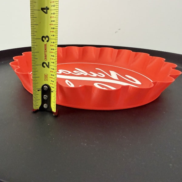 Side view of Nuka Cola bottle cap wall hook replica with tape measure showing thickness of the wall mounted prop.